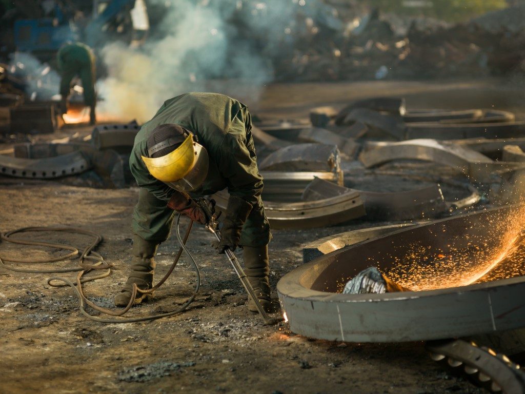 welder on recycling site